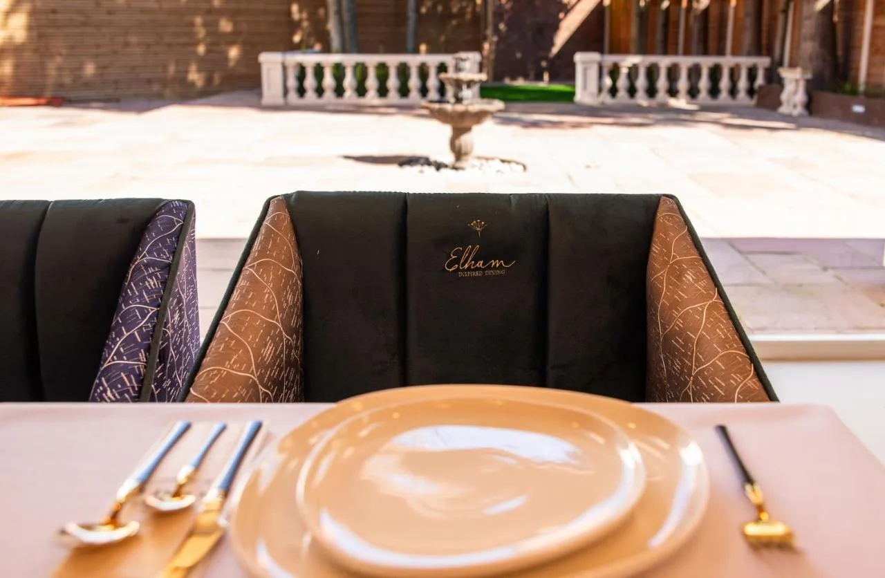 a table with an empty plate on a table at Domo Boutique Hotel Birmingham in Birmingham