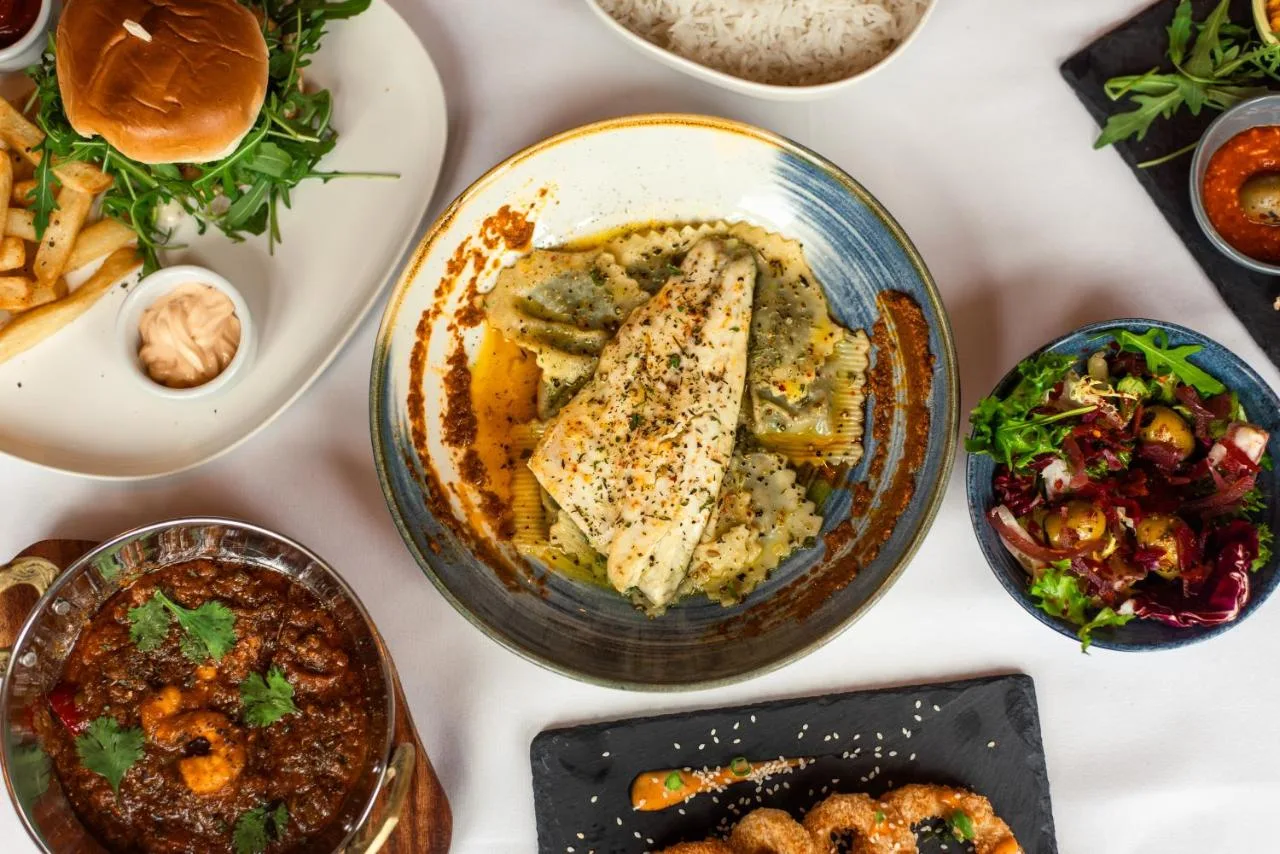 a table filled with different types of food at Domo Boutique Hotel Birmingham in Birmingham